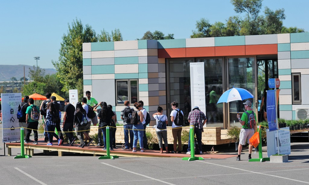 Visitors line up to tour Crowder College and Drury University during the U.S. Department of Energy Solar Decathlon at the Orange County Great Park, Irvine, California Friday, Oct. 9, 2015. (Credit: Thomas Kelsey/U.S. Department of Energy Solar Decathlon)